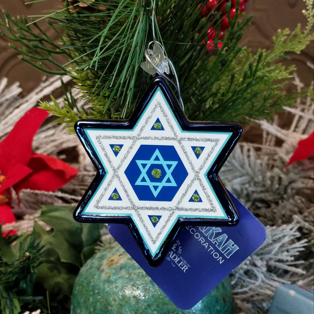 Glass made into the Star of David ornament in blue, white, and silver hues.