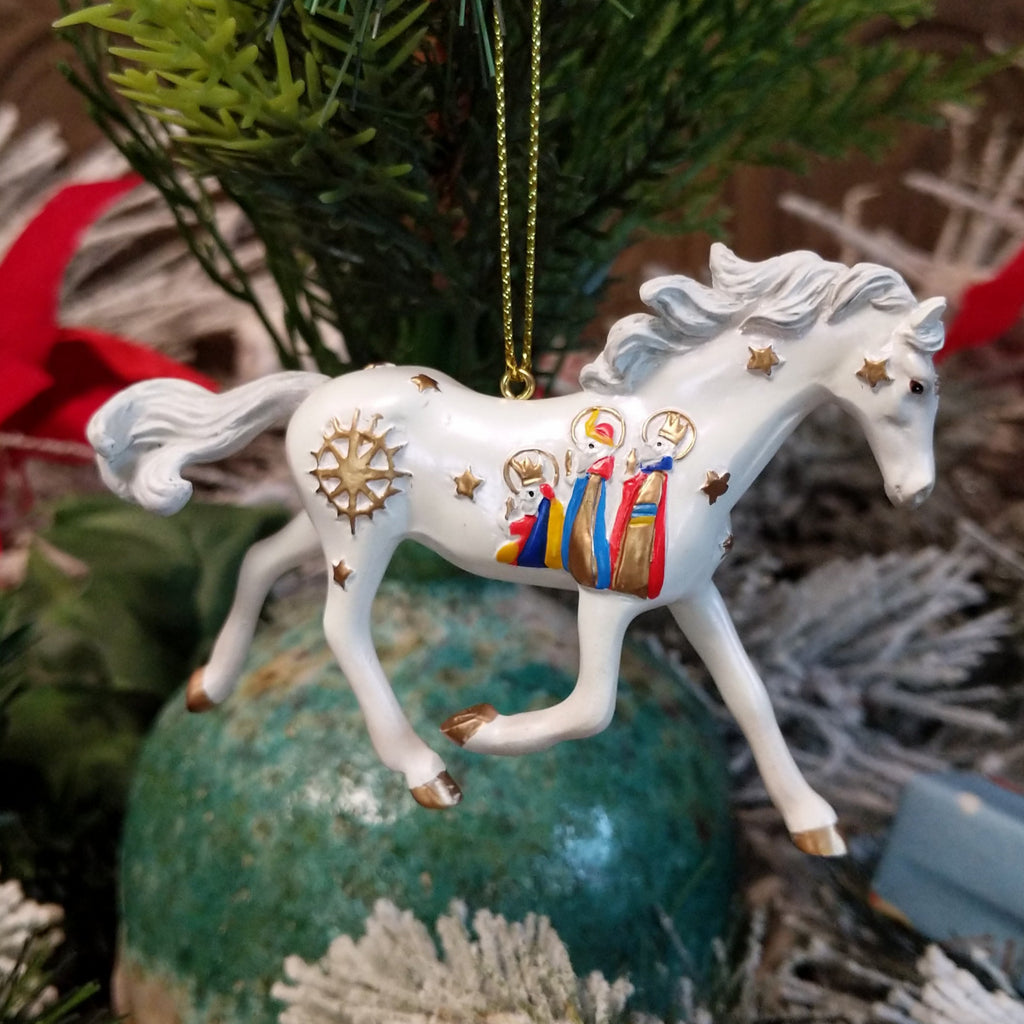 Resin made into a white painted pony with the three wise men and stars along its body.