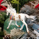 Resin made into a white painted pony with the three wise men and stars along its body.