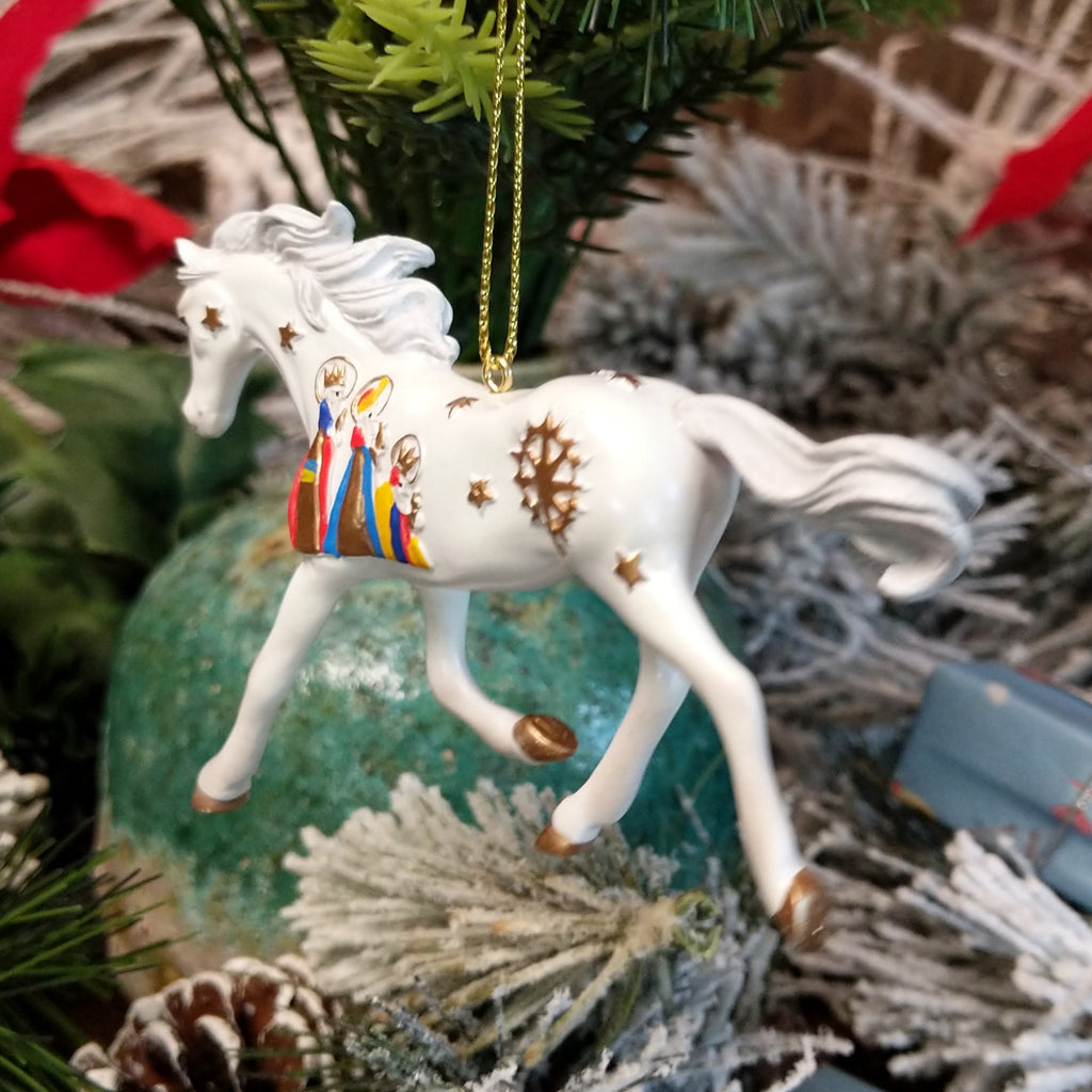 Resin made into a white painted pony with the three wise men and stars along its body.