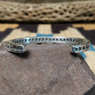 Starred sterling silver cuff by Sunshine Reeves, featuring hand-stamped star motifs and intricate geometric patterns on a handcrafted open sterling silver cuff.  Underside view.