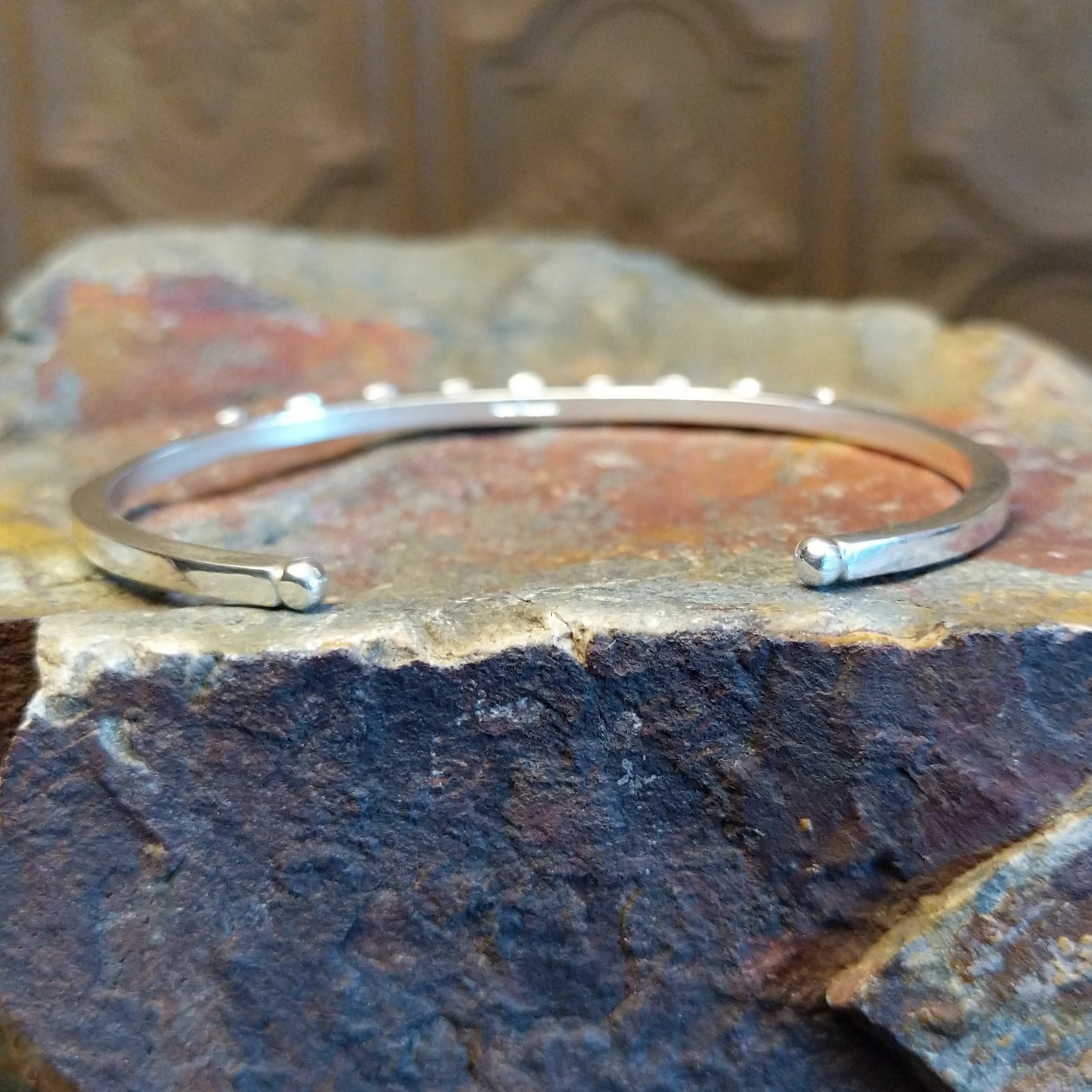 Sterling silver cuff bracelet with starry beadwork along the band and lapis centerpiece set in the round bezel.
