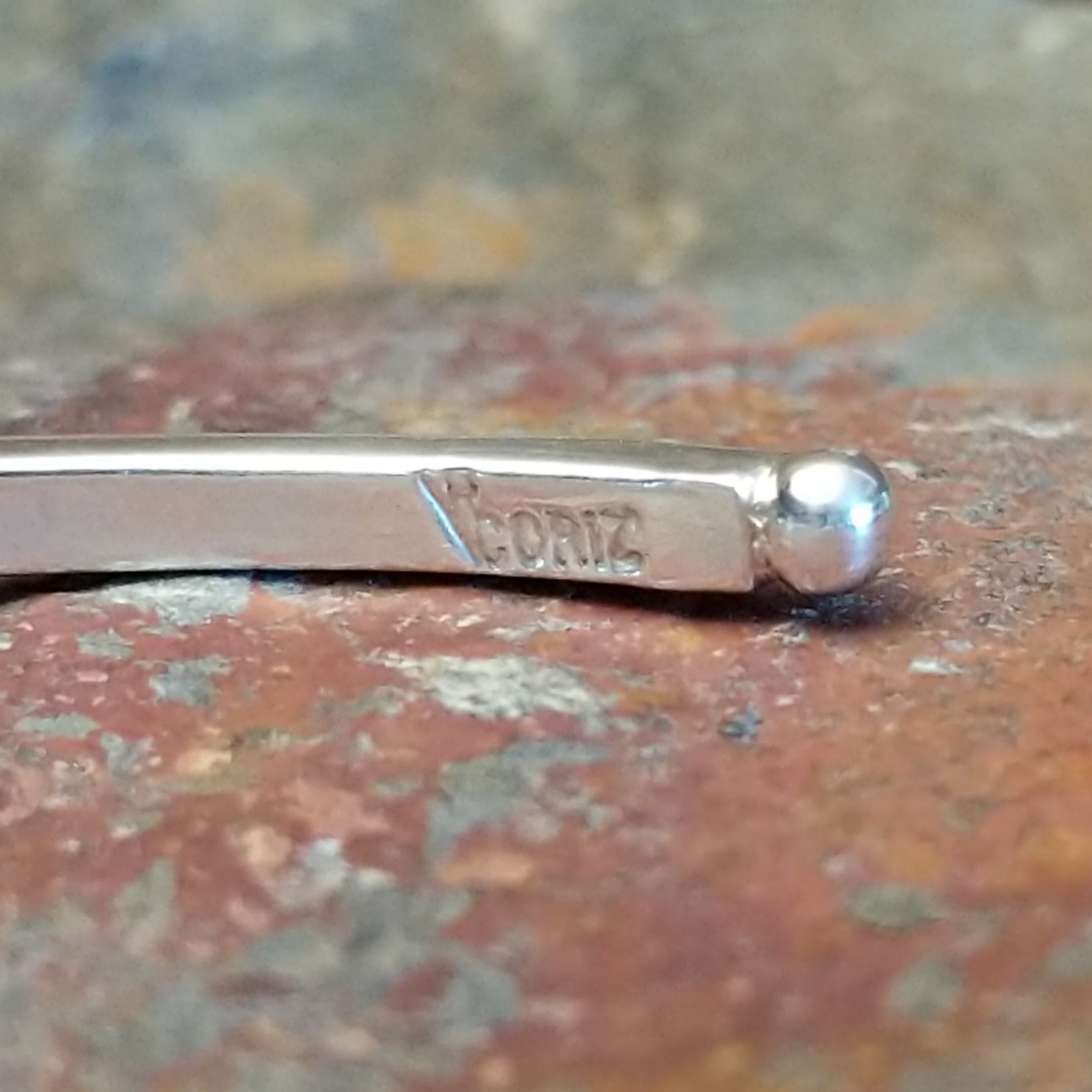 Close-up of the artisan's stamped signature.