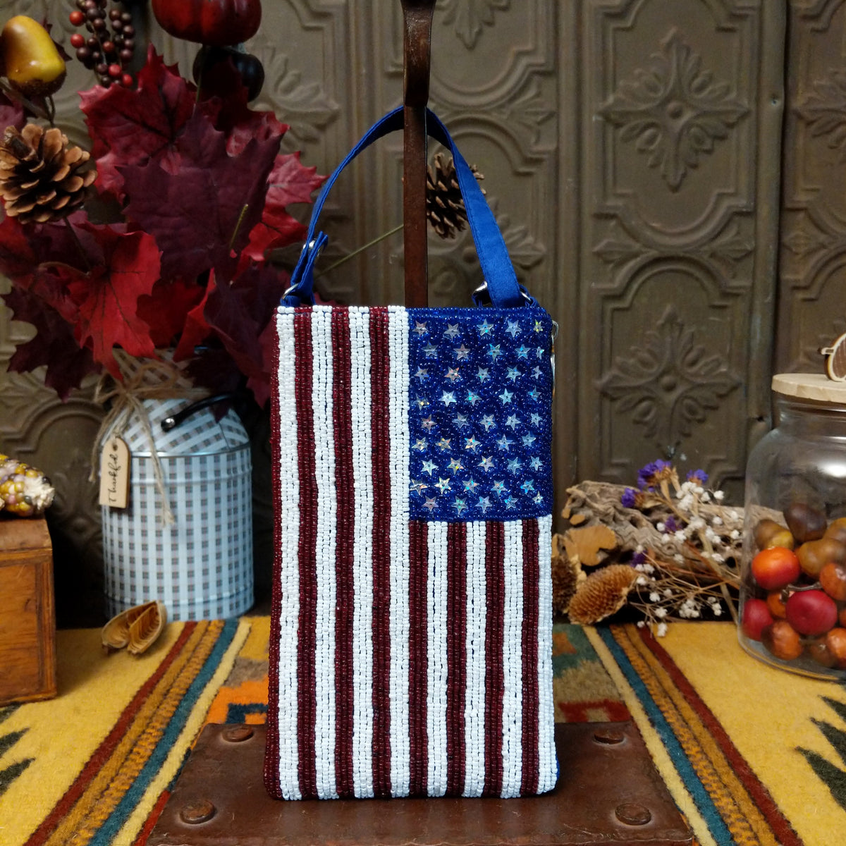 Stars & Stripes Club Bag by Bamboo Trading featuring an American flag design with red and white beaded stripes, sparkling silver stars on a blue background, and a coordinating blue shoulder strap.