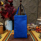 Stars & Stripes Club Bag by Bamboo Trading featuring an American flag design with red and white beaded stripes, sparkling silver stars on a blue background, and a coordinating blue shoulder strap; rear view.