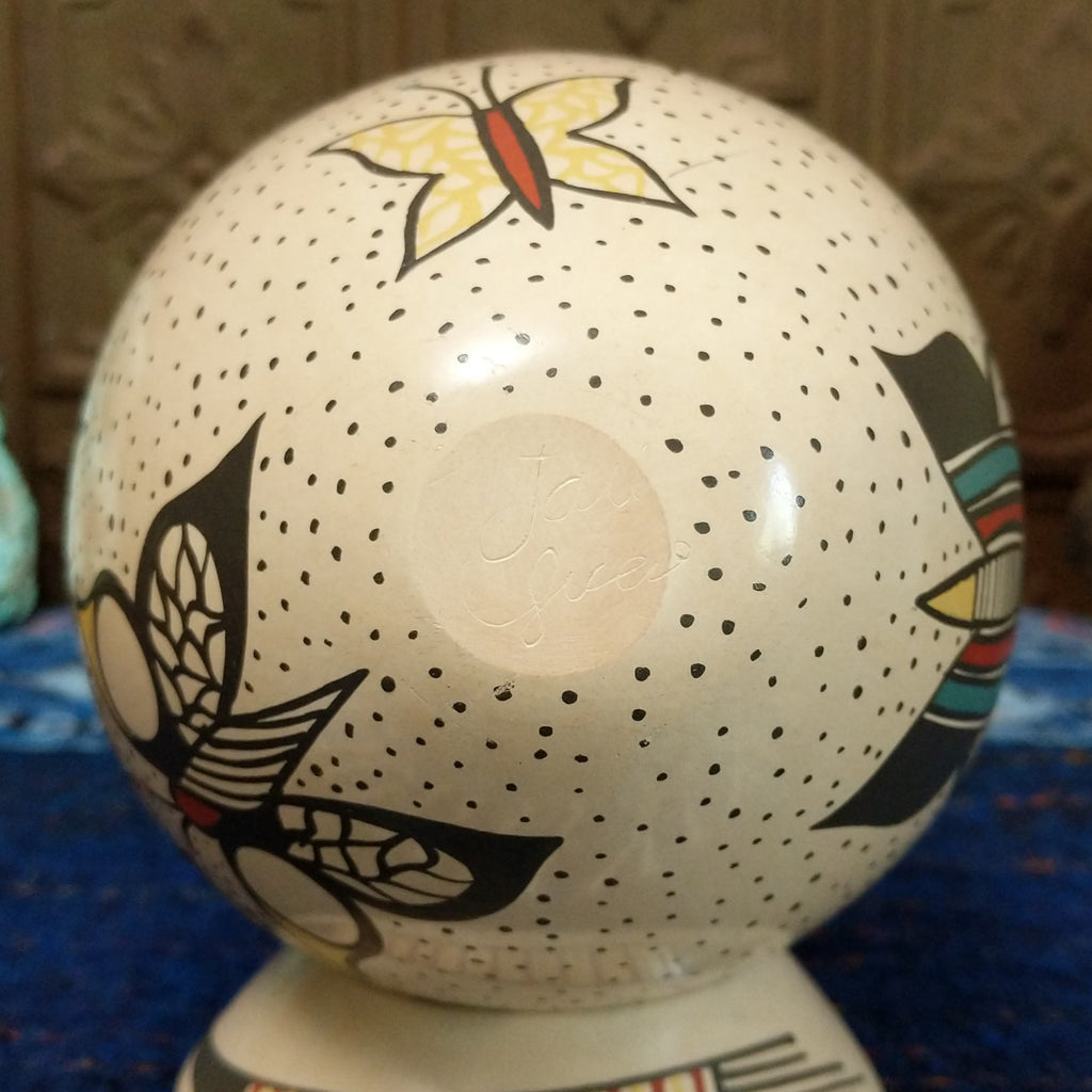 The base is etched with the artist's signature.