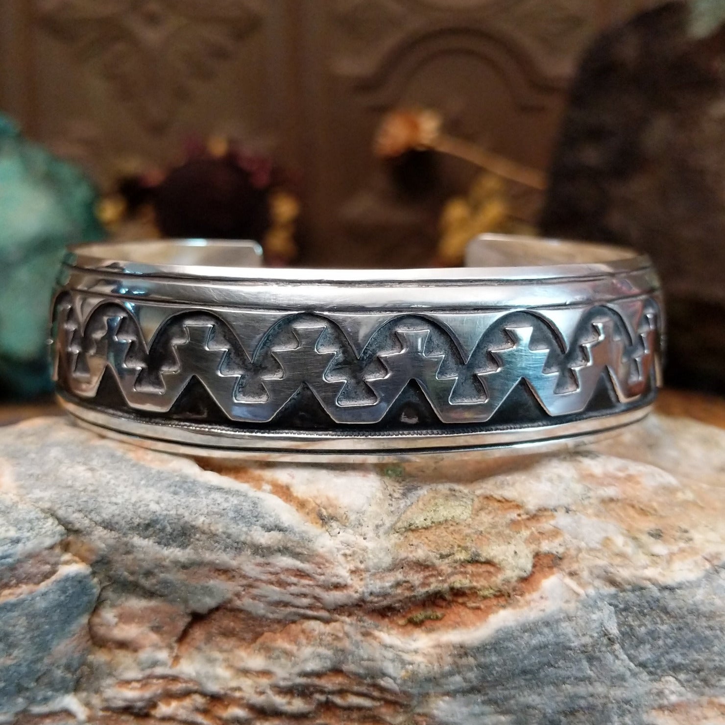 Sterling silver overlay cuff bracelet with repeating geometric motifs and oxidized detailing.