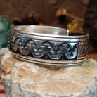 Sterling silver overlay cuff bracelet with repeating geometric motifs and oxidized detailing.