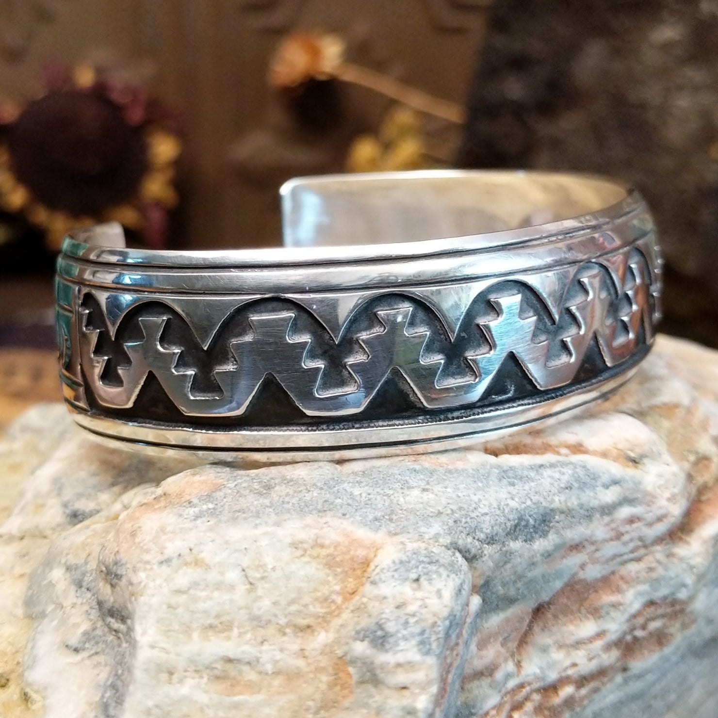 Sterling silver overlay cuff bracelet with repeating geometric motifs and oxidized detailing.