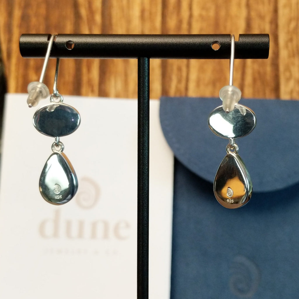 The back of the earrings showcase the silver authentication stamp and brand.