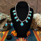 Sterling silver necklace and earrings set with Sonoran Gold turquoise set in notched bezels, framed by dotted accents and a beaded silver chain.