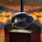 Close-up of the artisan's stamped signature.