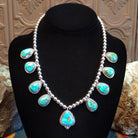 Sterling silver necklace with Sonoran Gold turquoise set in notched bezels, framed by dotted accents and a beaded silver chain.