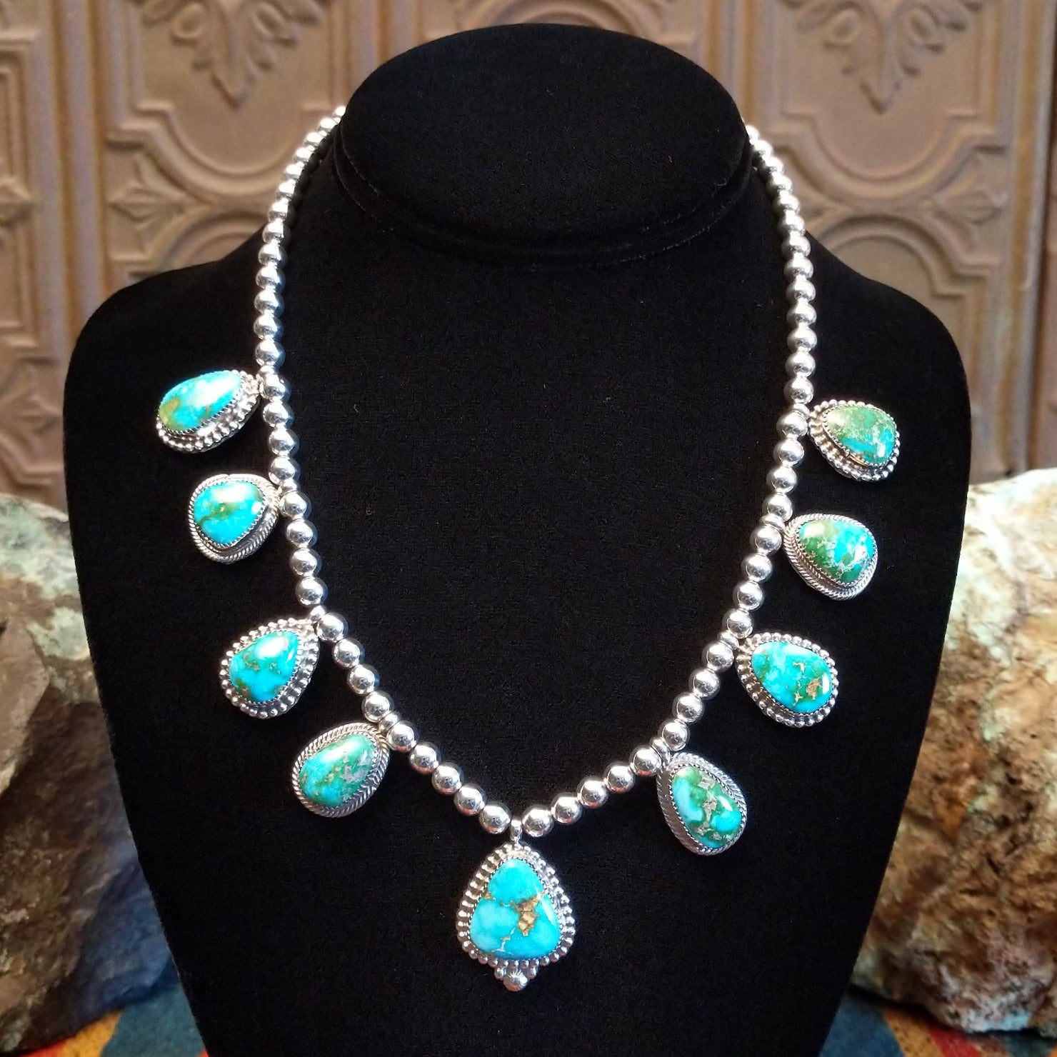 Sterling silver necklace with Sonoran Gold turquoise set in notched bezels, framed by dotted accents and a beaded silver chain.