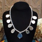 Sterling silver necklace with Sonoran Gold turquoise set in notched bezels, framed by dotted accents and a beaded silver chain.