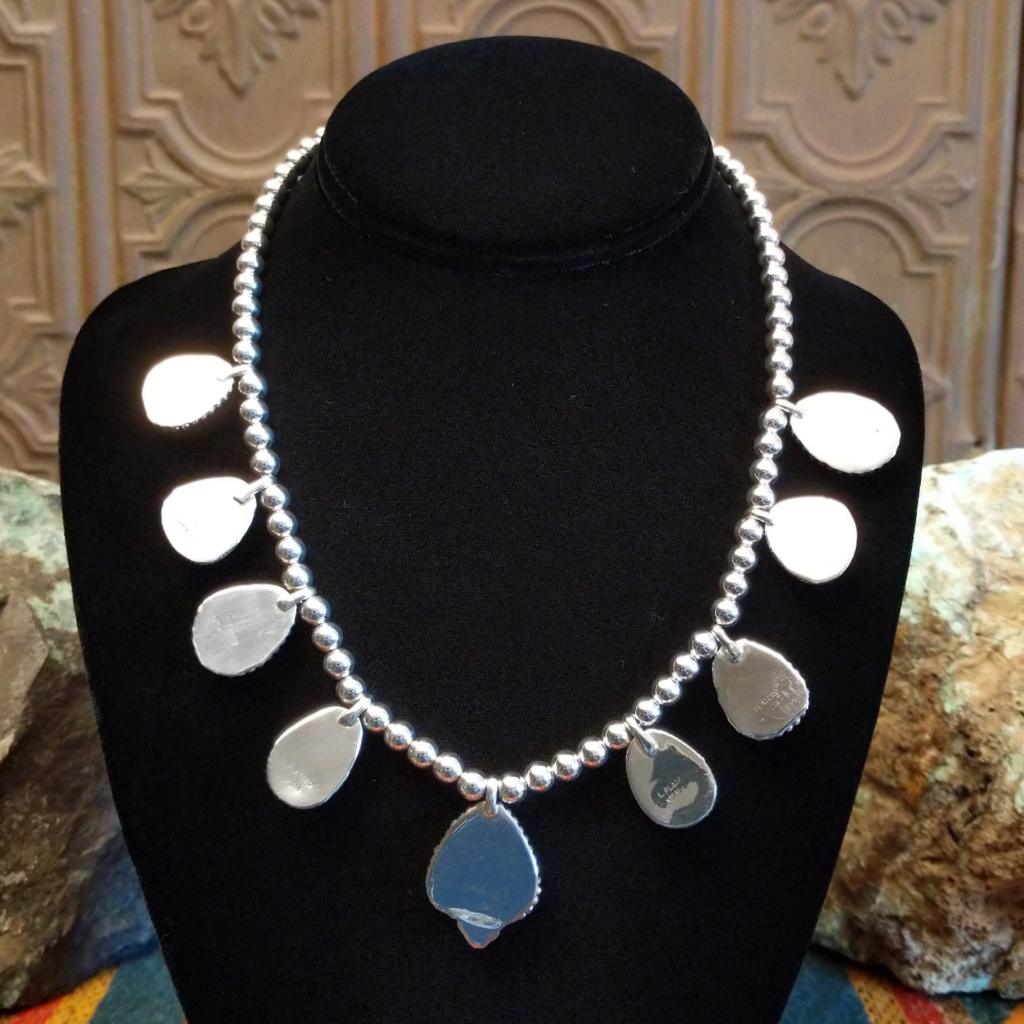 Sterling silver necklace with Sonoran Gold turquoise set in notched bezels, framed by dotted accents and a beaded silver chain.