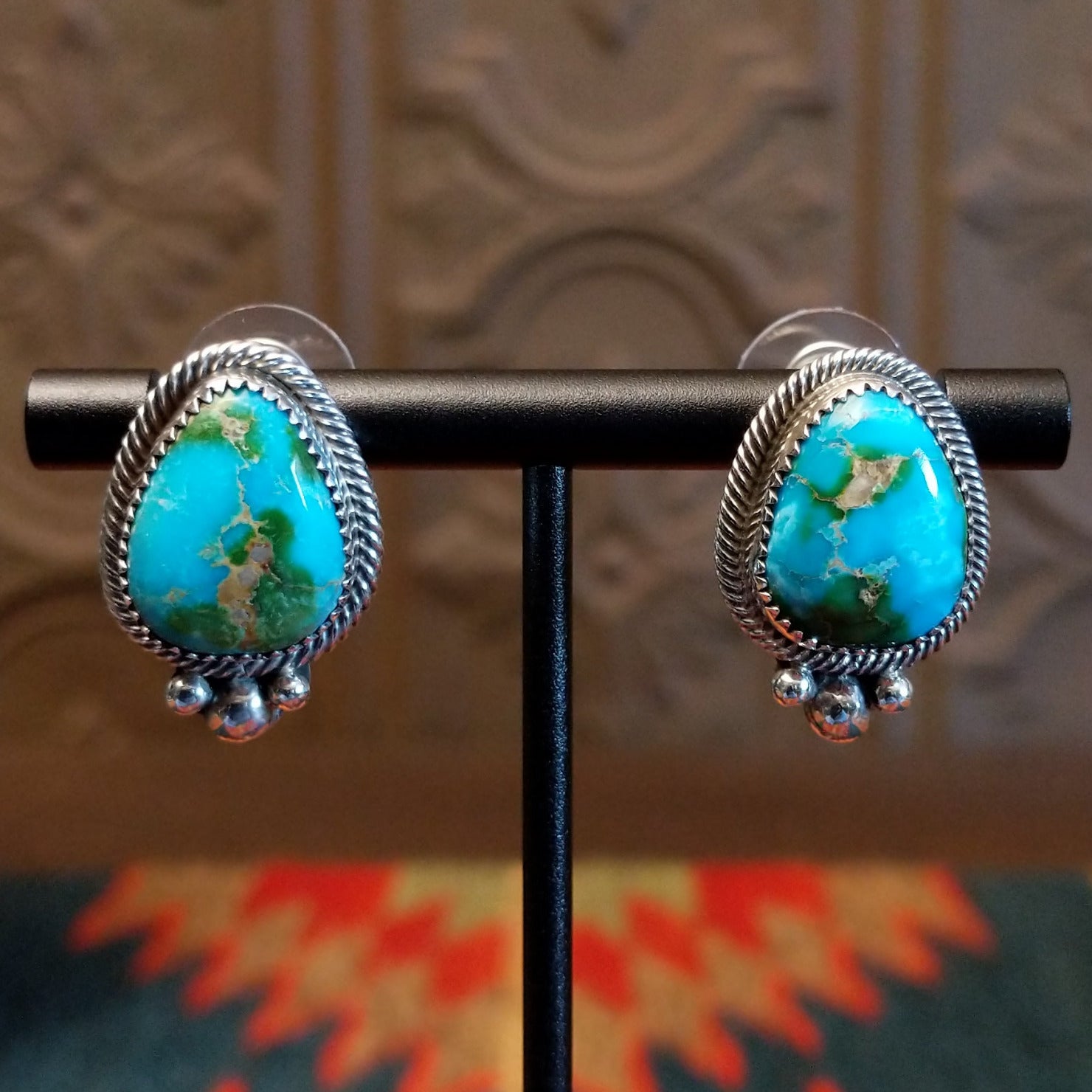 Sterling silver earrings with Sonoran Gold turquoise set in notched bezels, framed by dotted accents.