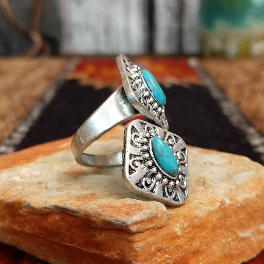 Nickel-free metal ring with a turquoise stone and ornate filigree detailing.