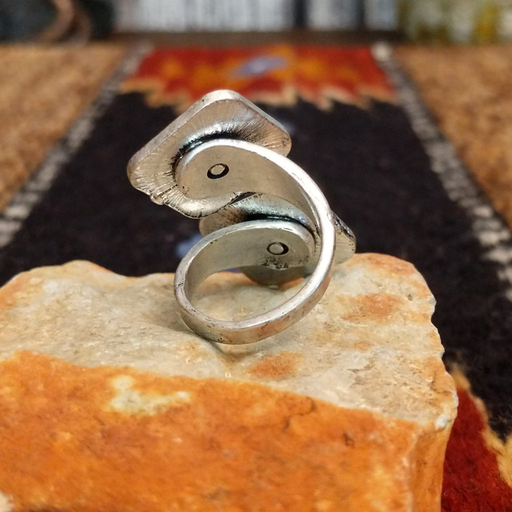 Back view showcases the twisted band of the ring.