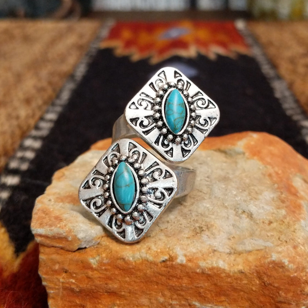 Nickel-free metal ring with a turquoise stone and ornate filigree detailing.