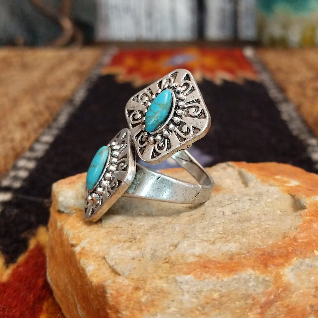 Nickel-free metal ring with a turquoise stone and ornate filigree detailing.