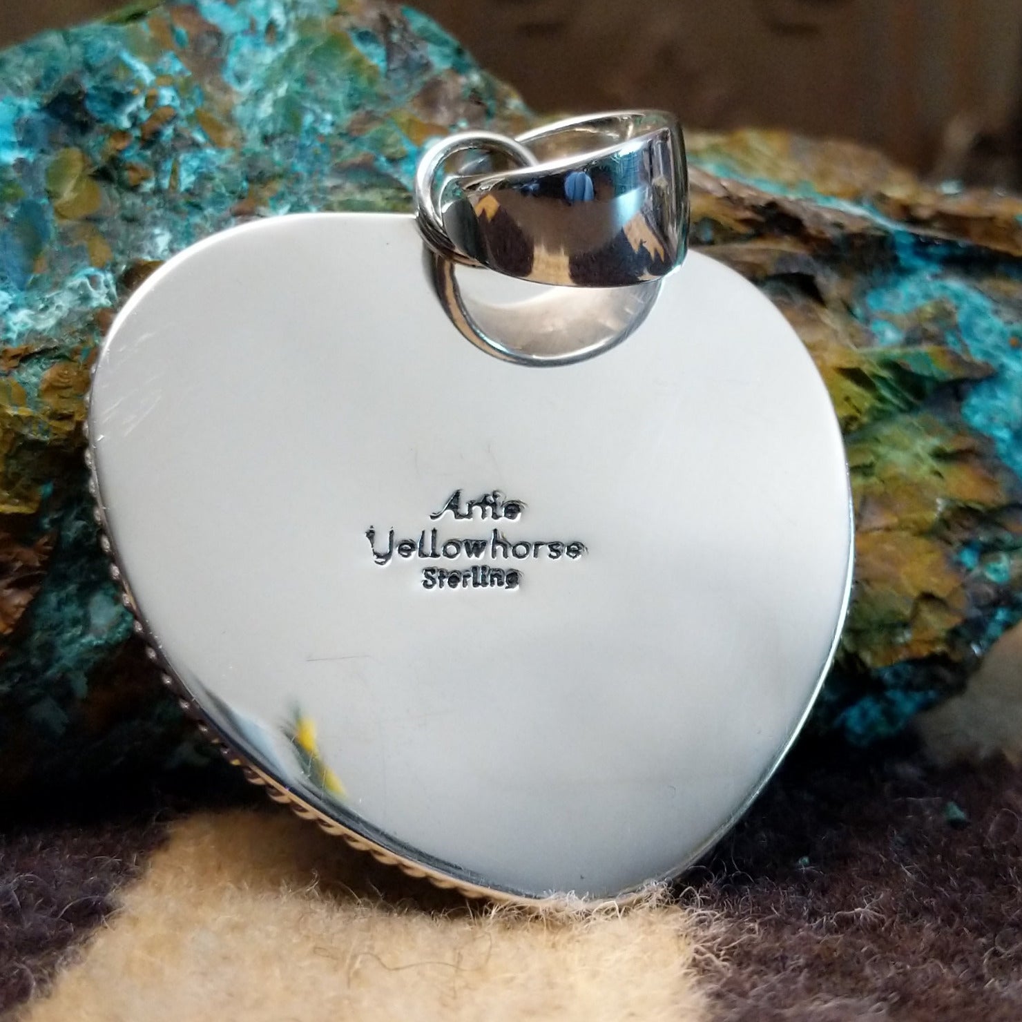 Close-up of the artisan's stamped signature.