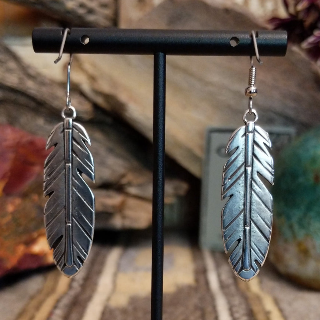 A pair of feather-shaped earrings.
