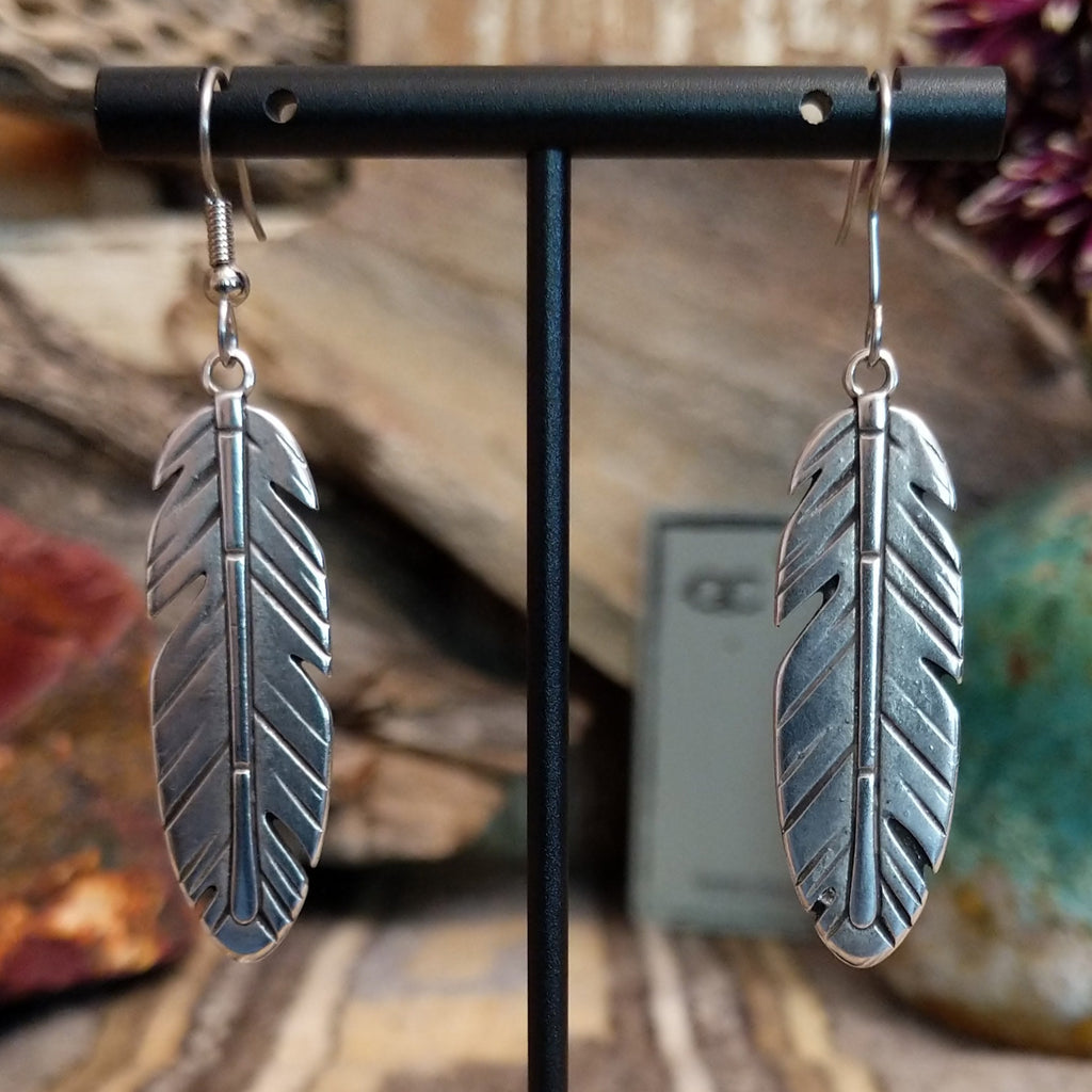 A pair of feather-shaped earrings.