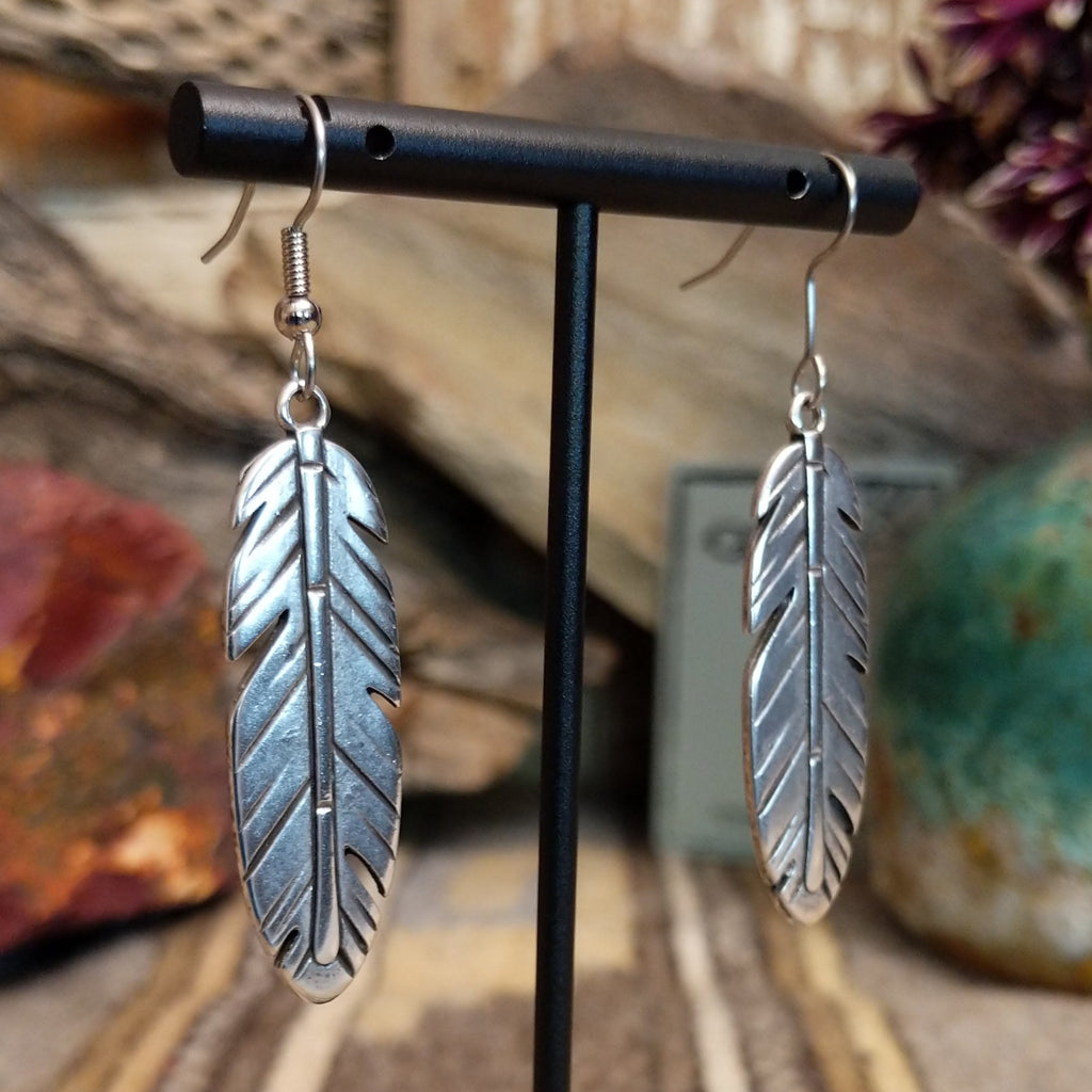 A pair of feather-shaped earrings.
