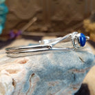 Sterling silver cuff with azurite malachite set in an oval bezel, framed by twisted rope accents.