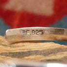 Close-up of the artisan's stamped signature.