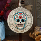 Sugar Skull Wood Ornament featuring a colorful floral skull with turquoise blue and red accents, engraved circular wooden frame, “Tombstone, AZ” lettering, and natural twine hanging loop.