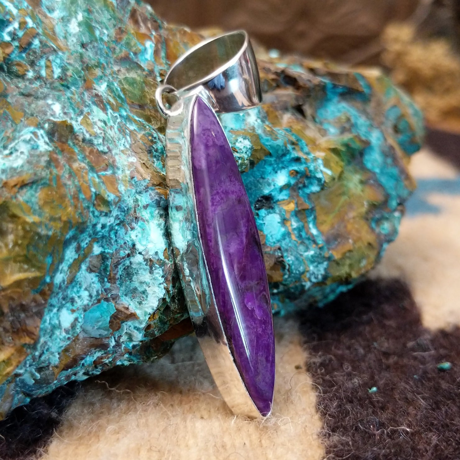 Sterling silver pendant with sugilite set in a navette bezel.