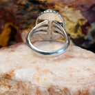 Sugilite framed by dotted accents, raised on the thin, sterling silver band.
