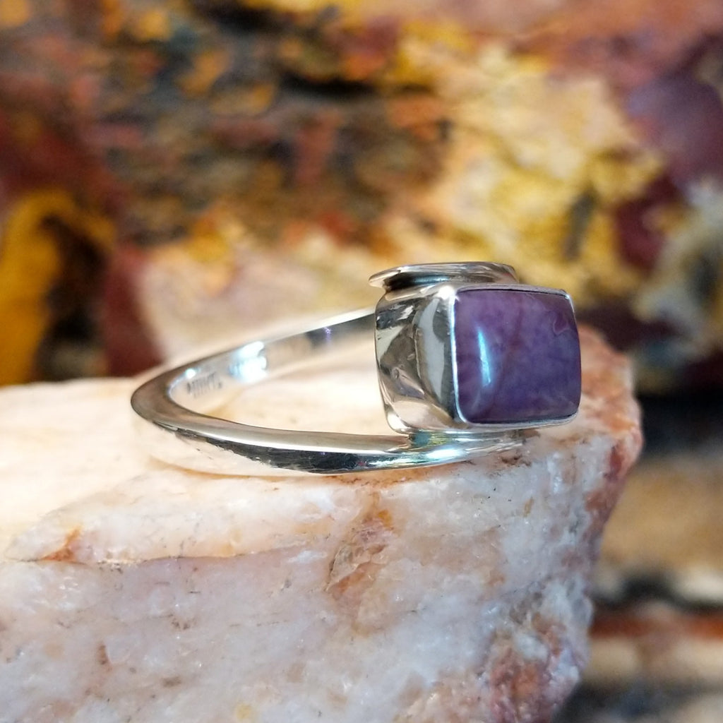 Sterling silver ring with a spiral band and sugilite stone set in the bezel.