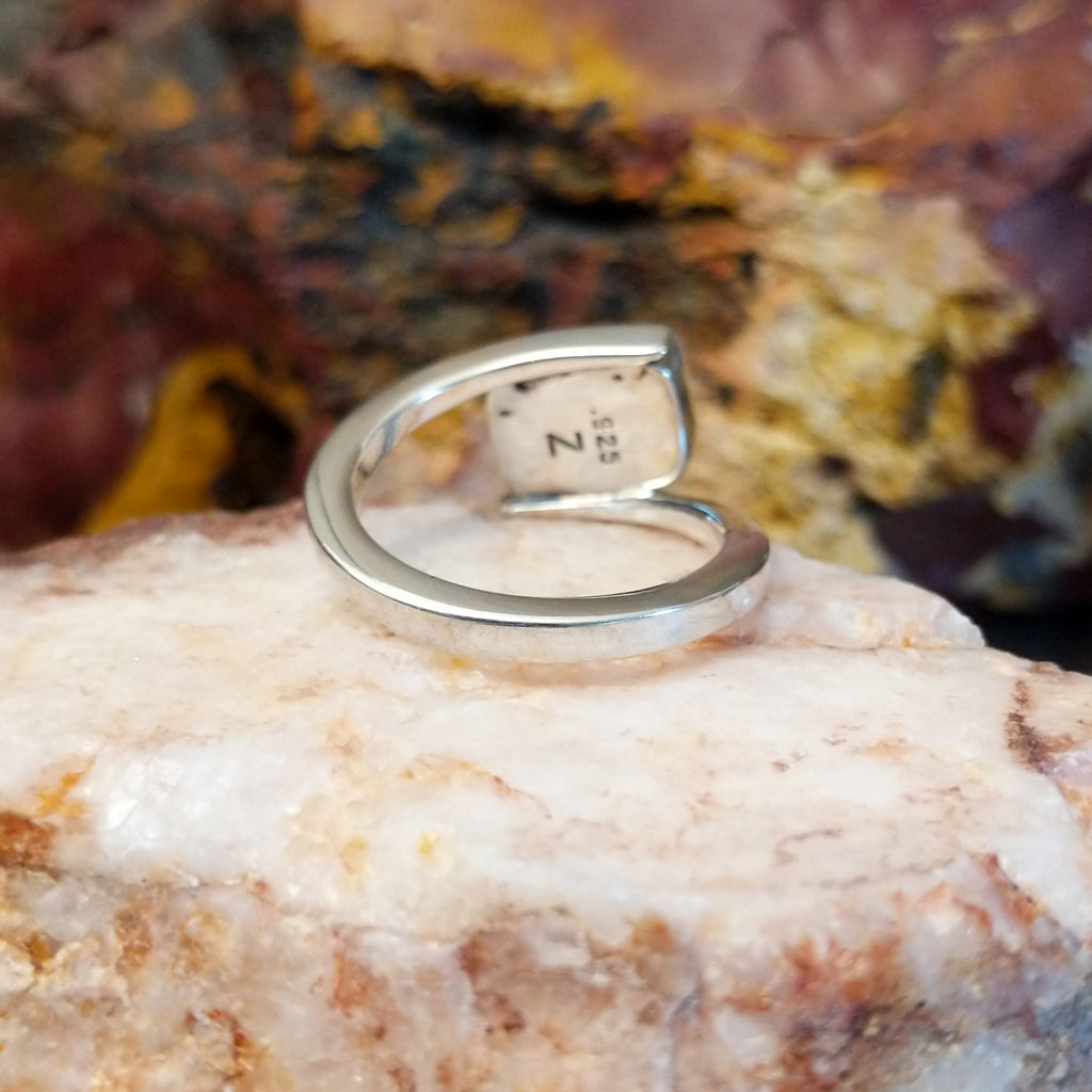 Sterling silver ring with a spiral band and sugilite stone set in the bezel.