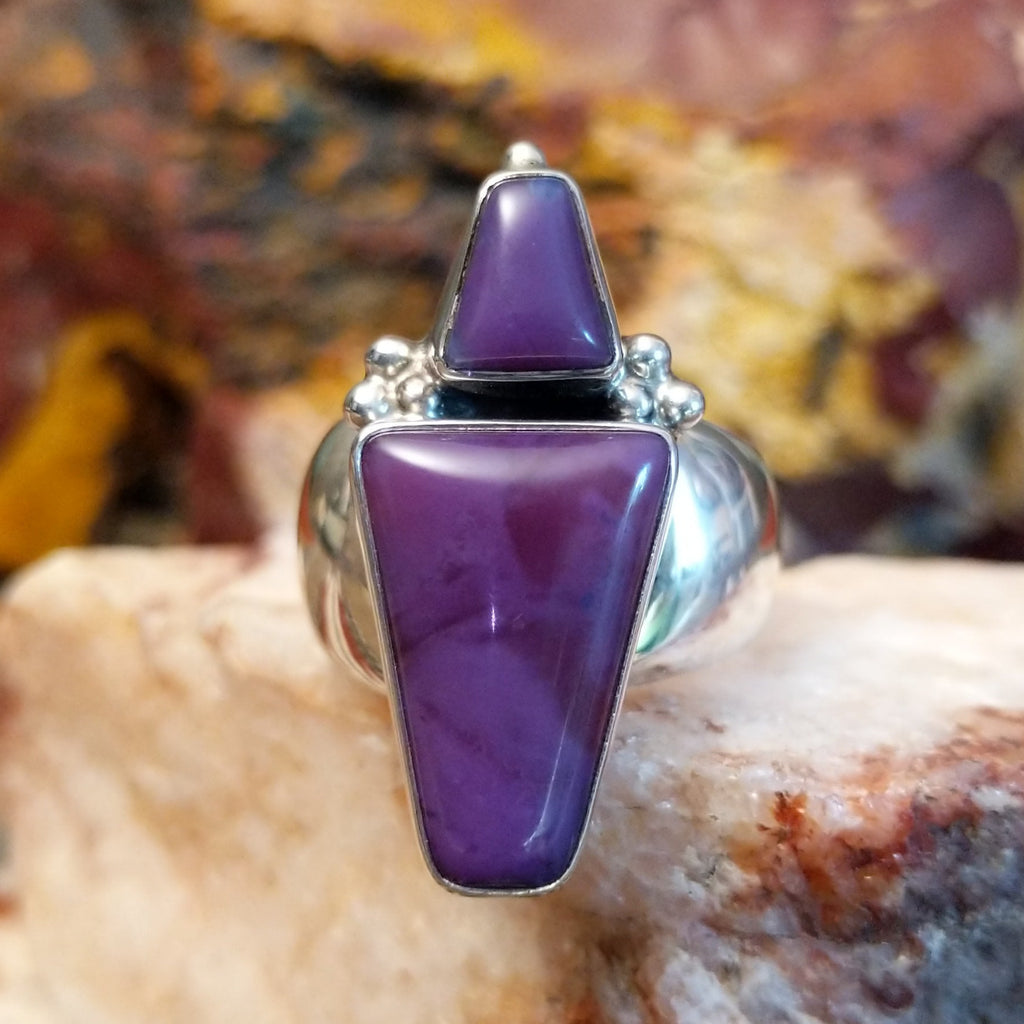 Trapezoid sugilite stones set within a sterling silver ring.