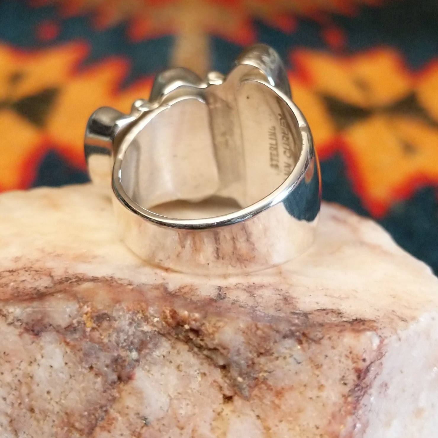 Sterling silver ring with unique bezels featuring sugilite set within.