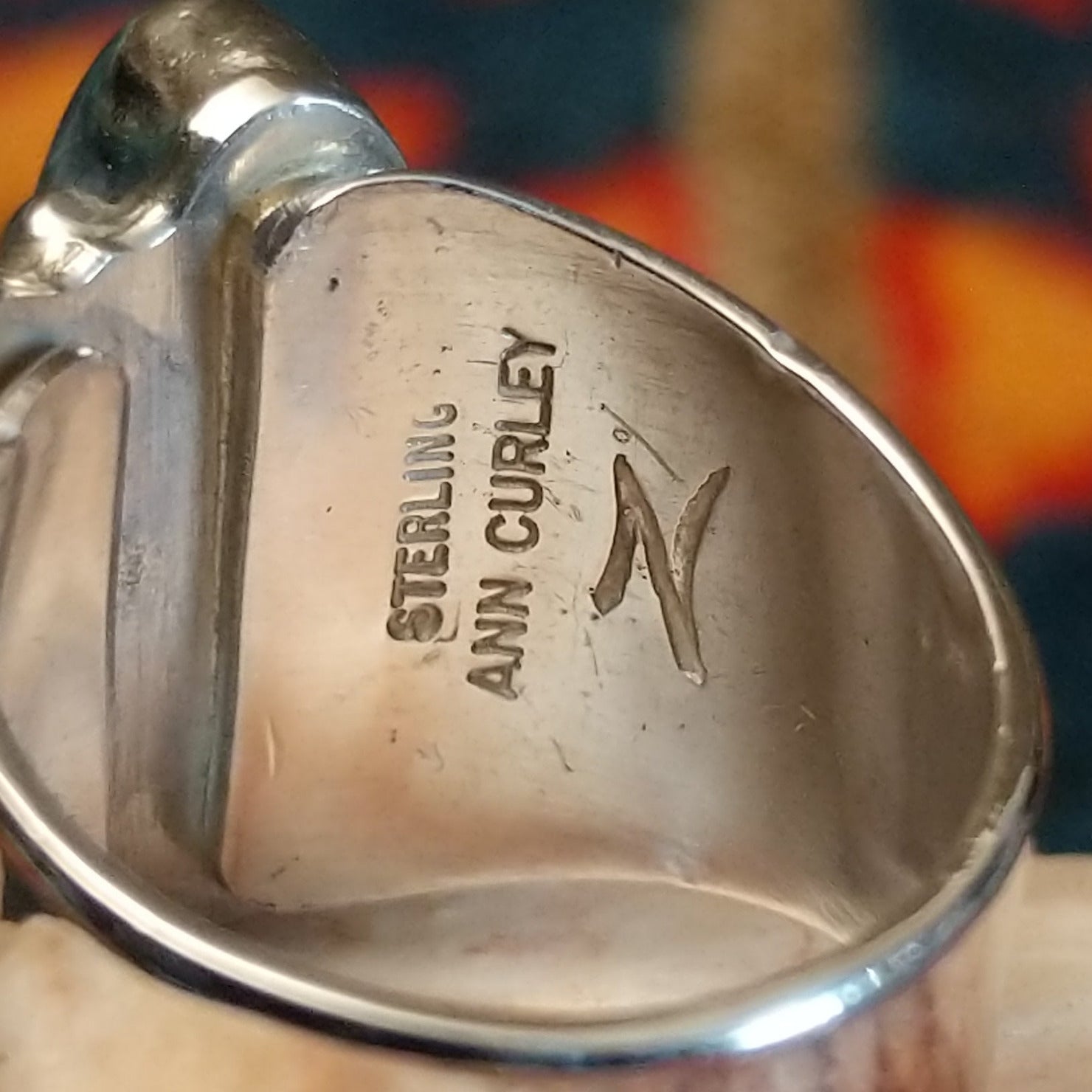 Close-up of the artisan's stamped signature.
