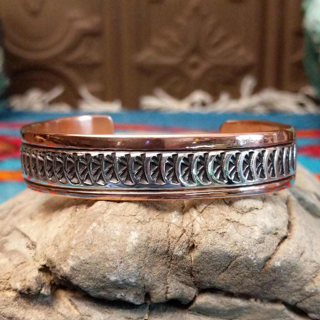 Copper and sterling silver cuff with sun beam stamping and polished finish.