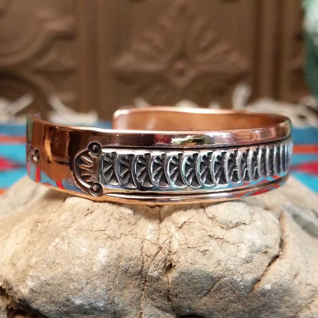 Copper and sterling silver cuff with sun beam stamping and polished finish.