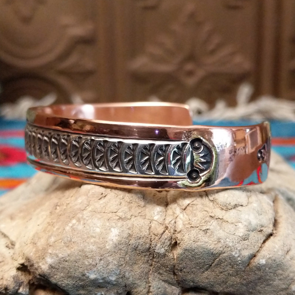 Copper and sterling silver cuff with sun beam stamping and polished finish.