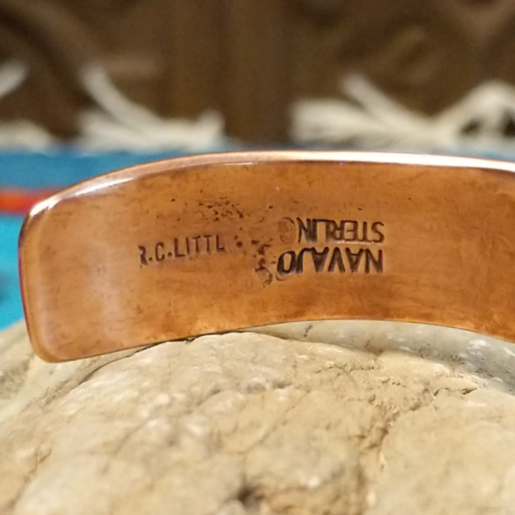 Close-up of the artisan's stamped signature.