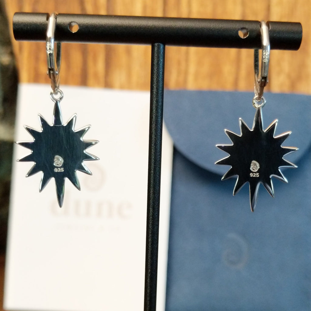 The back features the silver stamp with trademark.