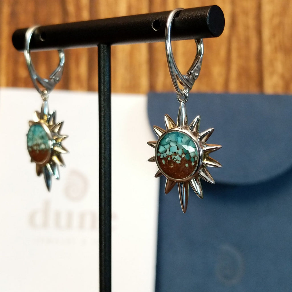 The front of the earrings feature turquoise and Lake Powell sand set in sun bezels with a lever-back closure on the earrings.