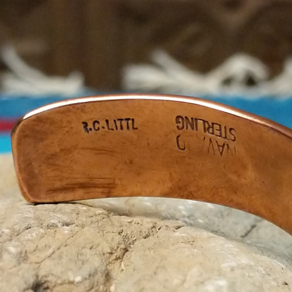 The artisan's signature is found on the interior of the cuff.
