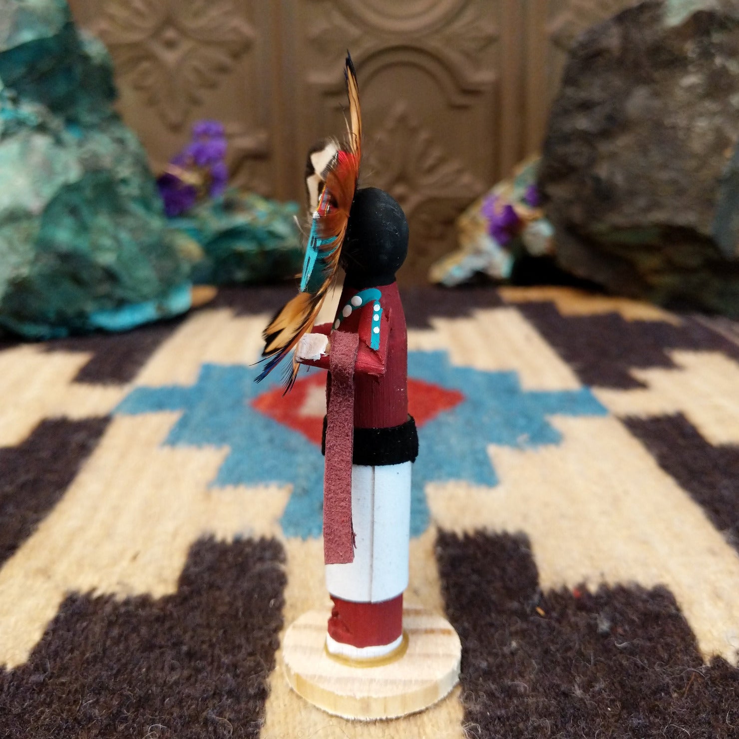 Mini Sunface kachina by Rosalind Grey with turquoise circular face, feathered halo, and white geometric-patterned garment.