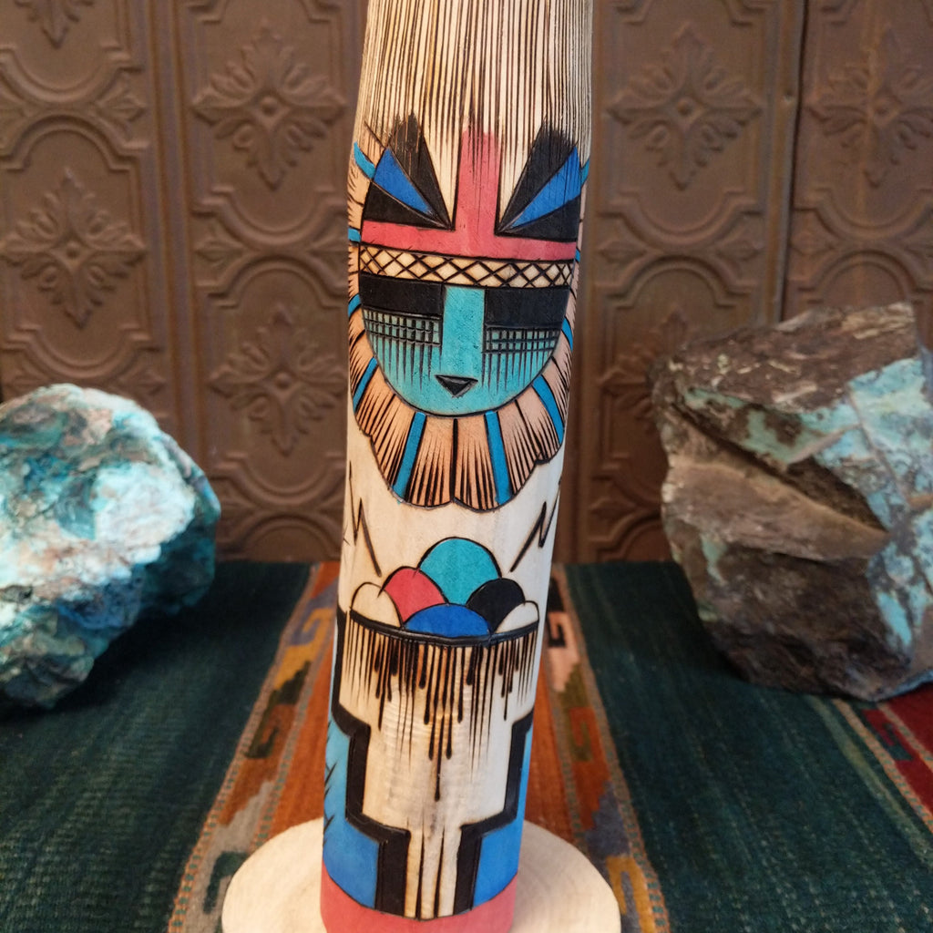 A close-up of the detailed sunface motifs on the body.