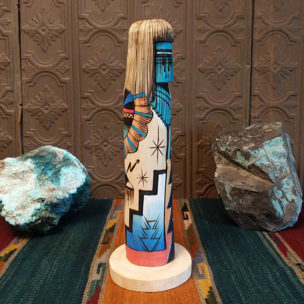 Sunface Shalako Kachina with a vibrant blue face and colorful designs all along the body.