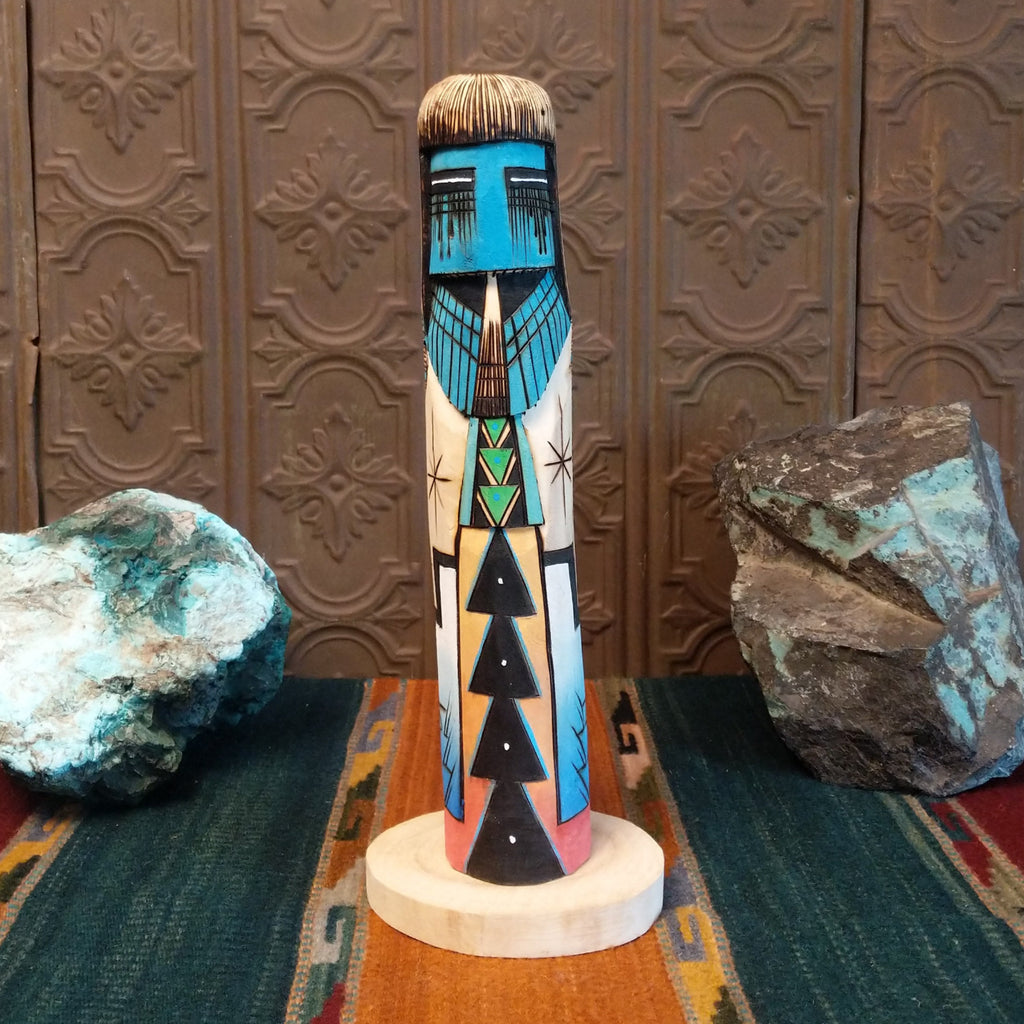 Sunface Shalako Kachina with a vibrant blue face and colorful designs all along the body.